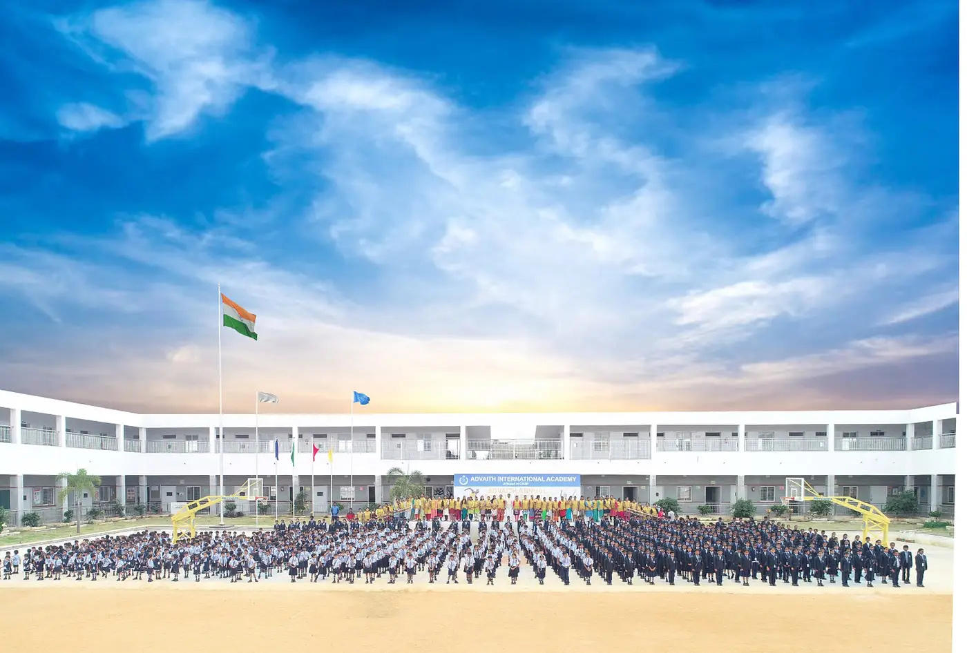 Students and staff in front of their school campus